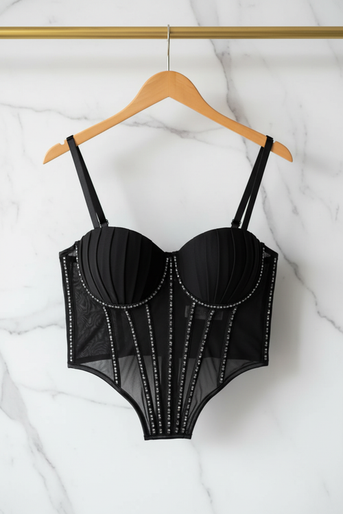 Black mesh corset bodysuit on hanger marble background